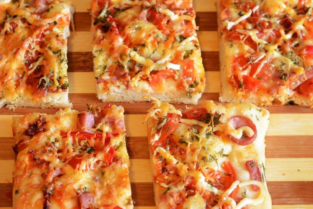 pizza quadrada com queijo tomate e calabresa picada