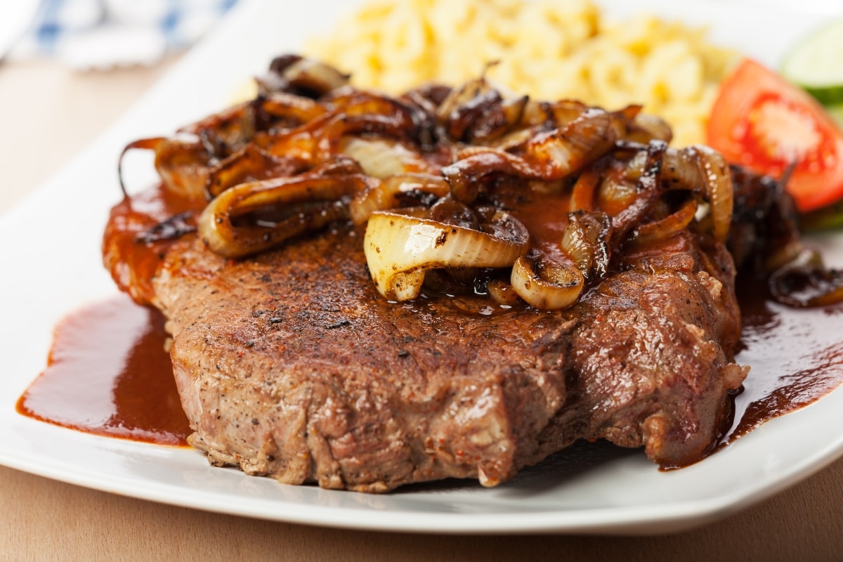 A combinação da carne suculenta com as cebolas caramelizadas resulta em um prato irresistível.