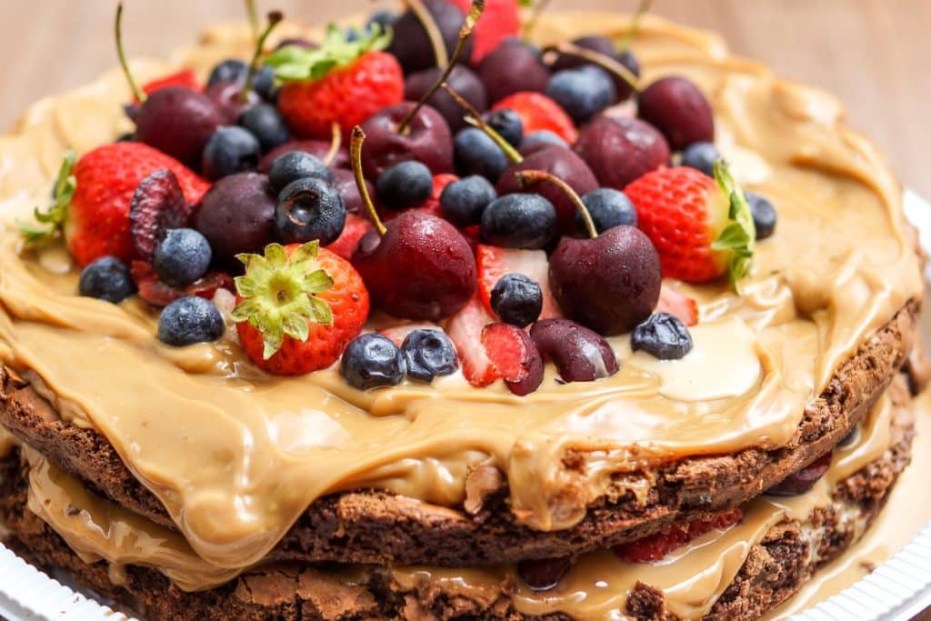 Receita de bolo de chocolate com recheio e cobertura de doce de leite com frutas